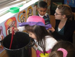 Children and research assistant engaging in dramatic play